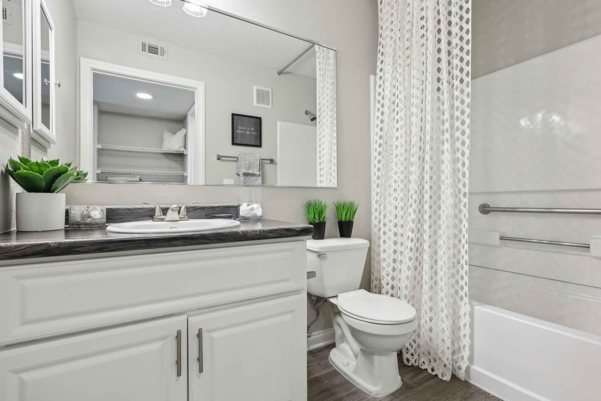 bathroom sink extra long mirror toilet shower tub at Millennium East