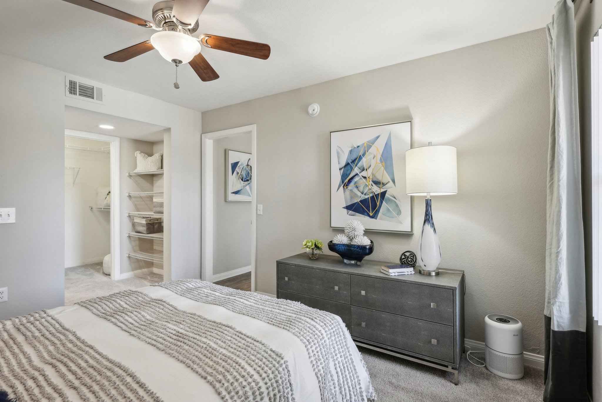 bedroom with dresser walk in closet at Millennium East