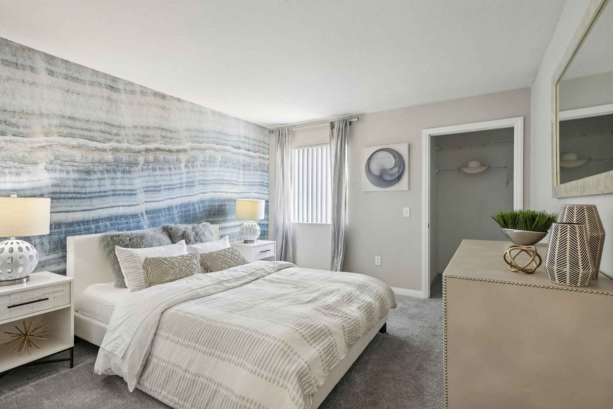 bedroom with bed decorative wall showing room with closet at Millennium East