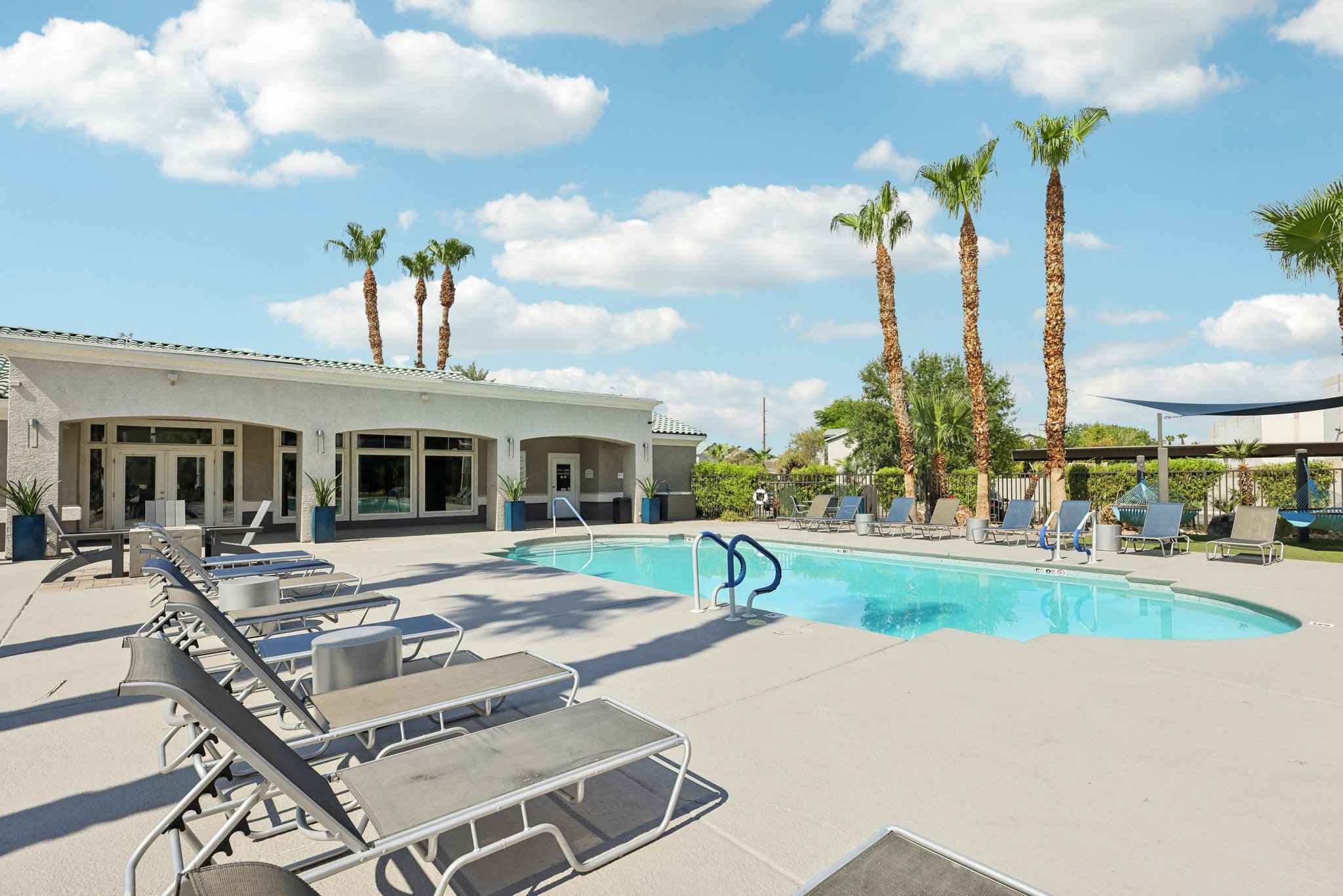 community pool lounge area pool chairs entrance to building at Millennium East
