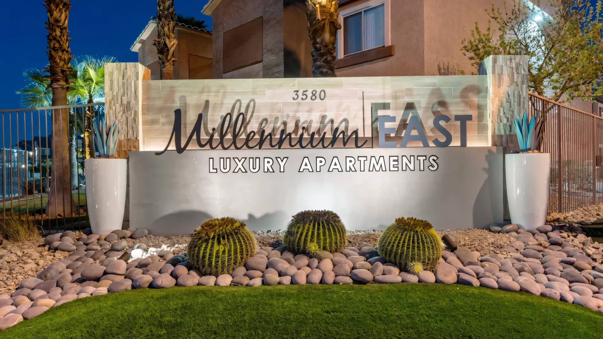 Millennium East Luxury Apartments Front Sign at Night