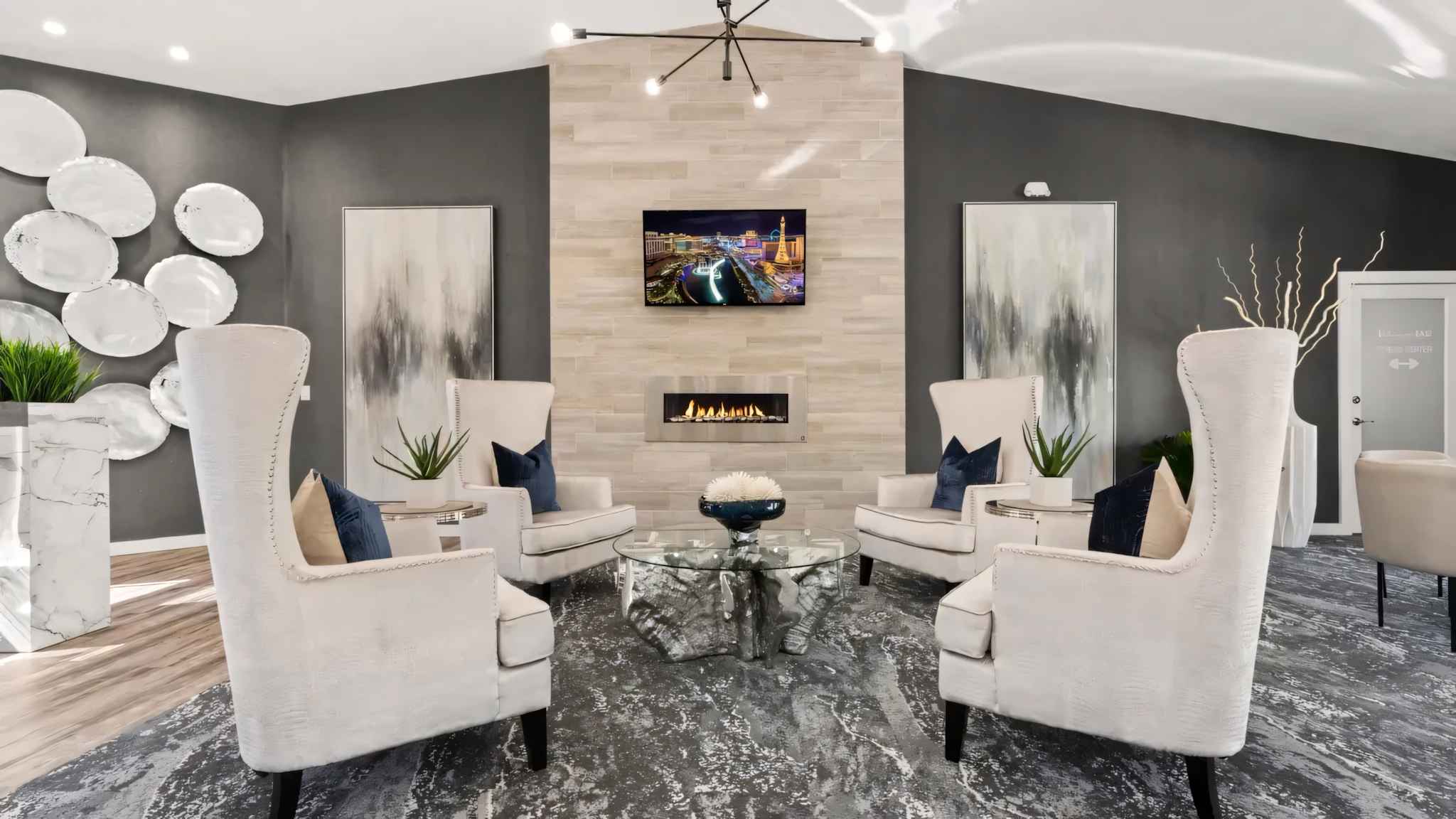 leasing office with seating area with tv and fire place at Millennium East